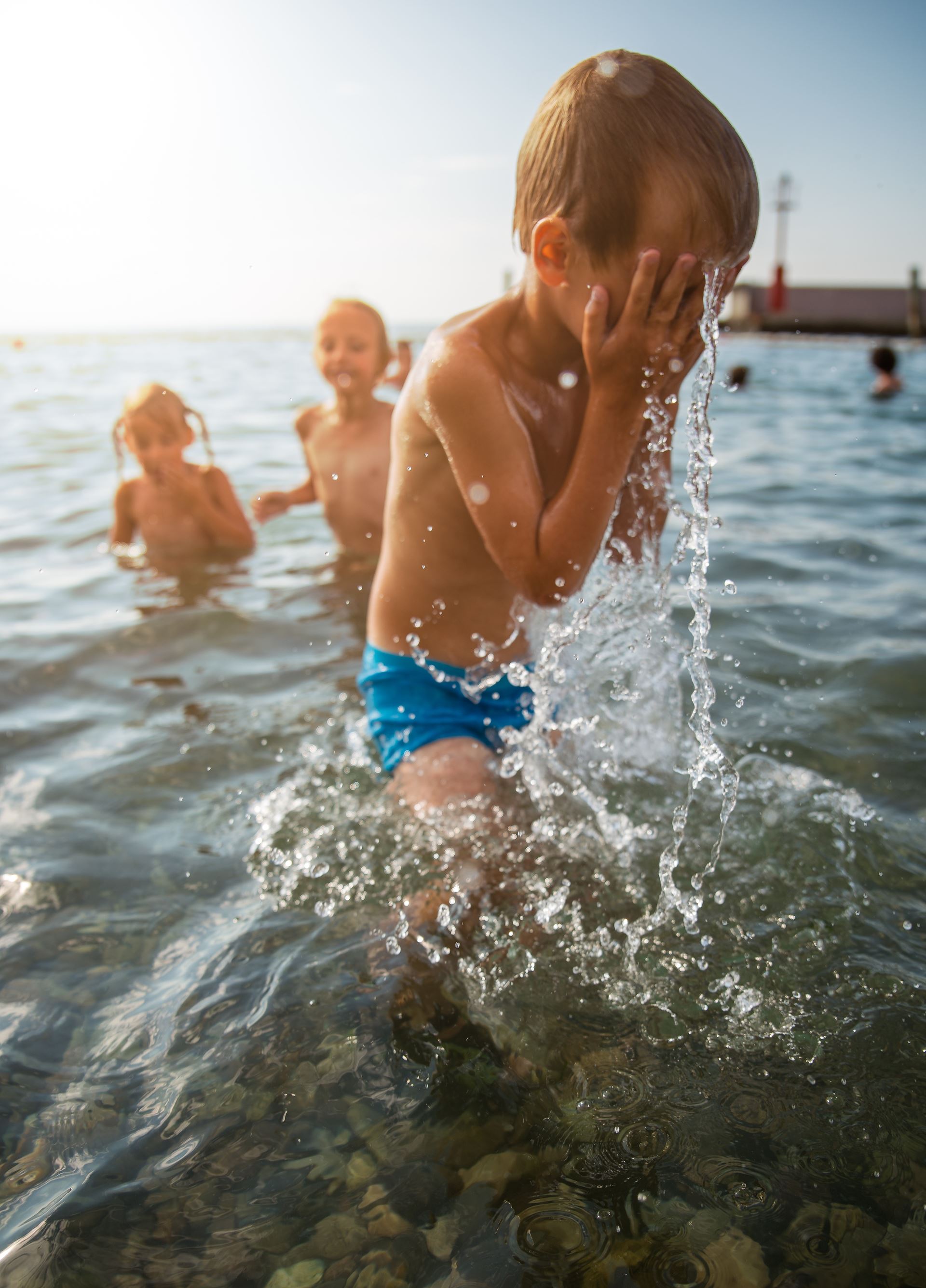 a young boy swimming in a body of water