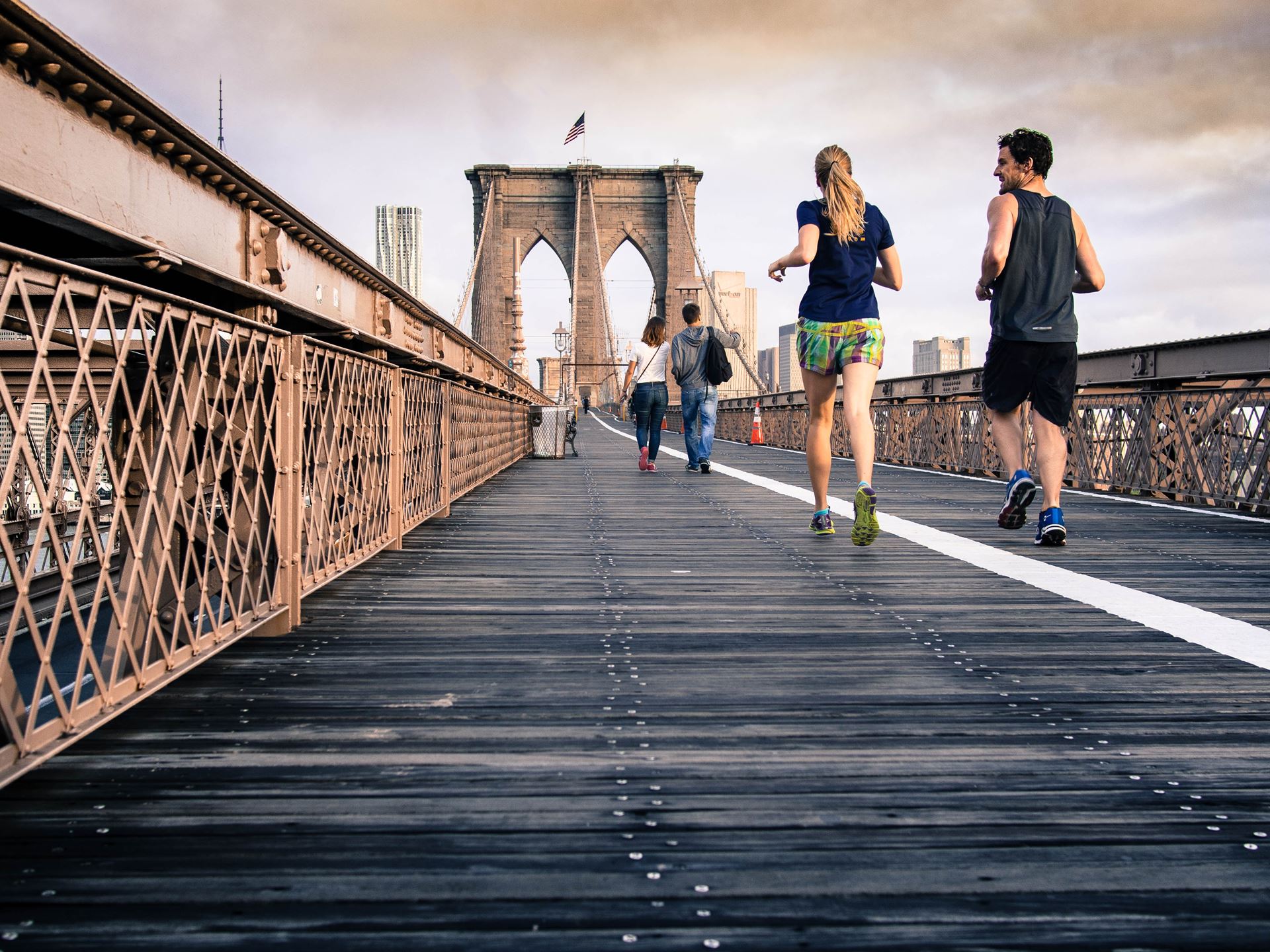 a group of people walking on a bridge